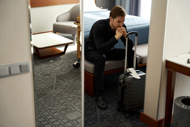 Man sitting alone and looking worried, illustrating feelings of self-doubt